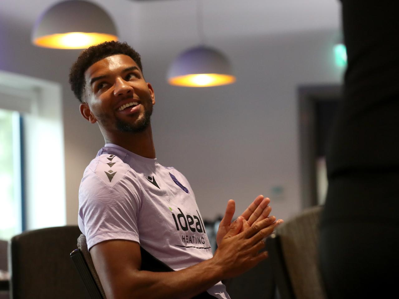 Mason Holgate smiling looking over his shoulder in the canteen