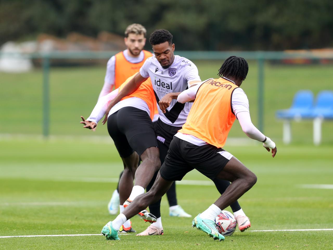 Grady Diangana trying to escape the challenge of two players during a training session 