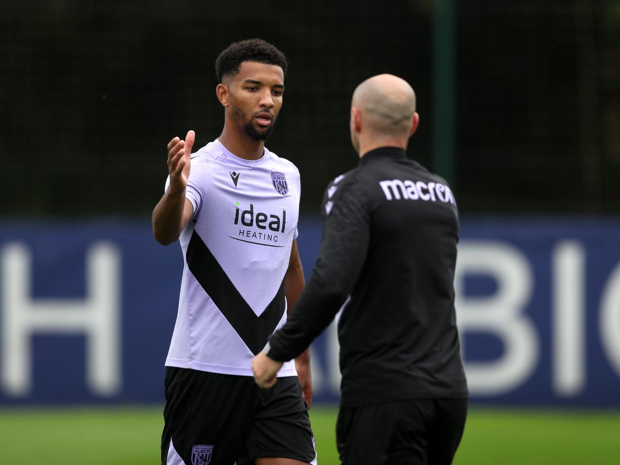 Mason Holgate high fives a member of staff out on the training pitch