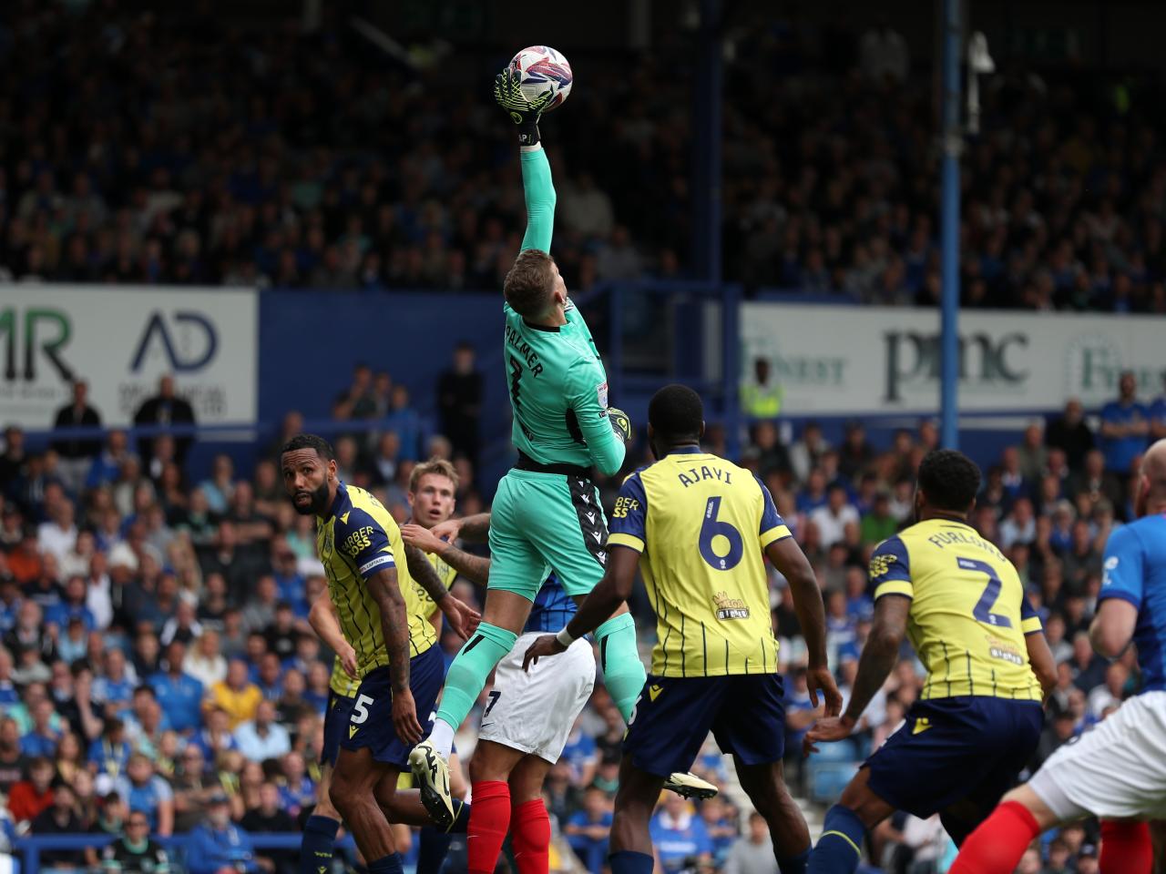 Albion in action against Portsmouth at Fratton Park, in yellow and blue away colours.