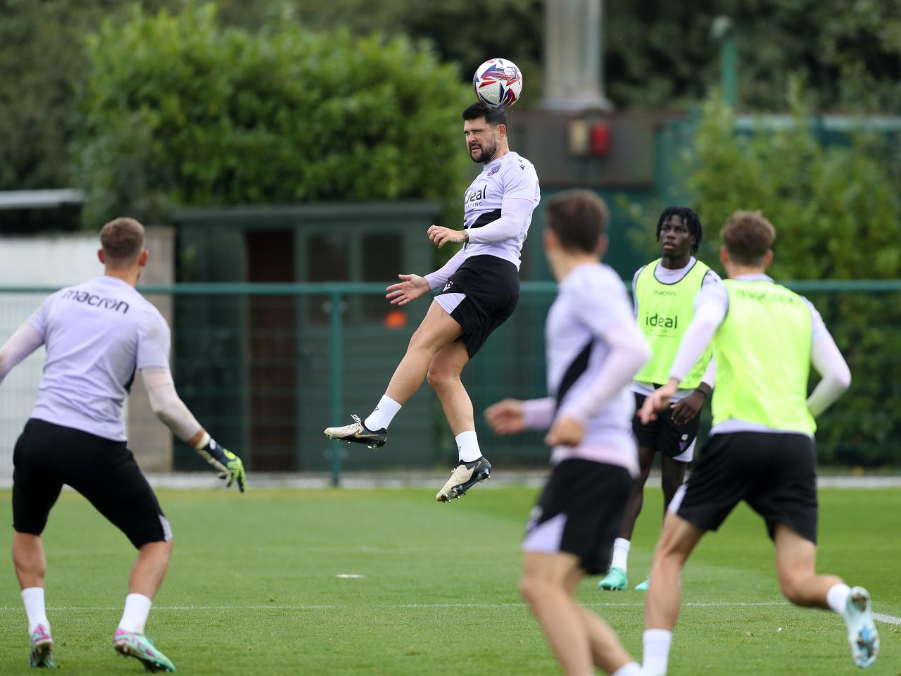 Alex Mowatt heading the ball during a training session 