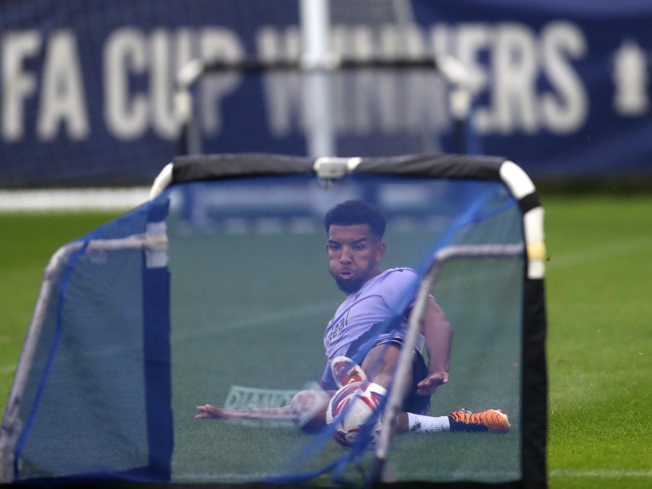 Mason Holgate sliding to reach a ball in front of a mini goal on the training pitch 