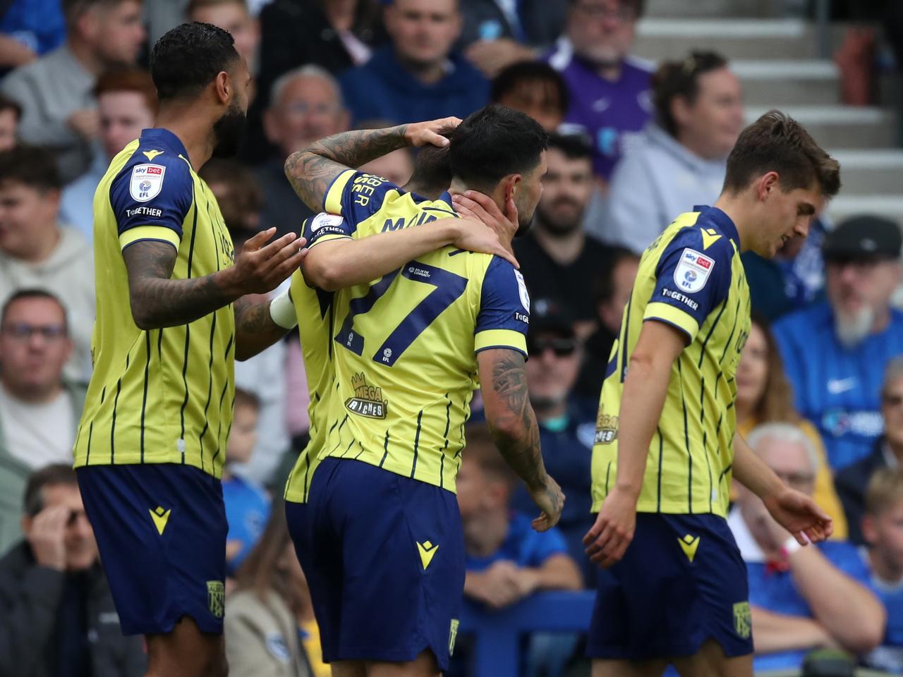 Albion in action against Portsmouth at Fratton Park, in yellow and blue away colours.