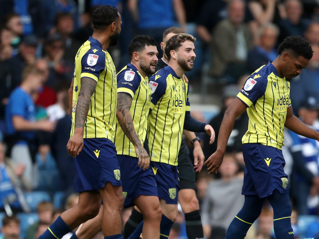 Albion in action against Portsmouth at Fratton Park, in yellow and blue away colours.