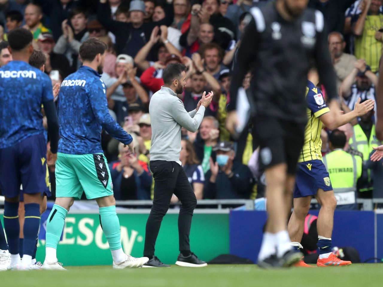 Albion in action against Portsmouth at Fratton Park, in yellow and blue away colours.