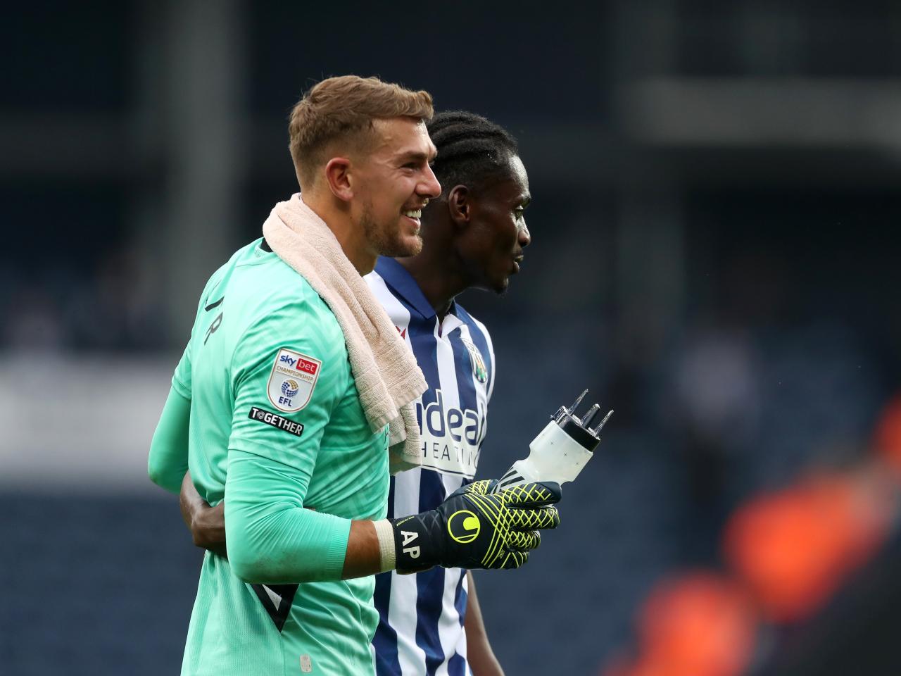 Alex Palmer and Ousmane Diakité embrace at full-time against Plymouth 