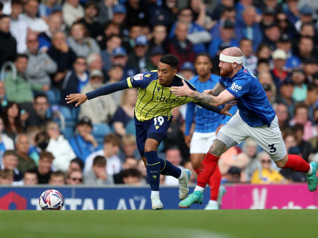 Albion in action against Portsmouth at Fratton Park, in yellow and blue away colours.