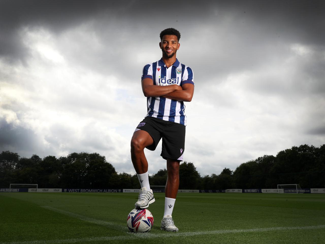 Mason Holgate stood on a training pitch in the home shirt with one foot on the ball and his arms crossed