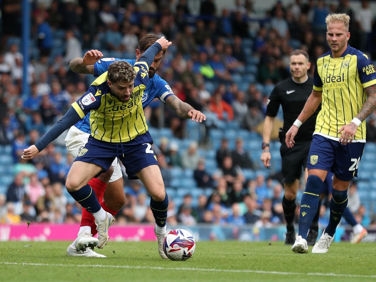 Albion in action against Portsmouth at Fratton Park, in yellow and blue away colours.