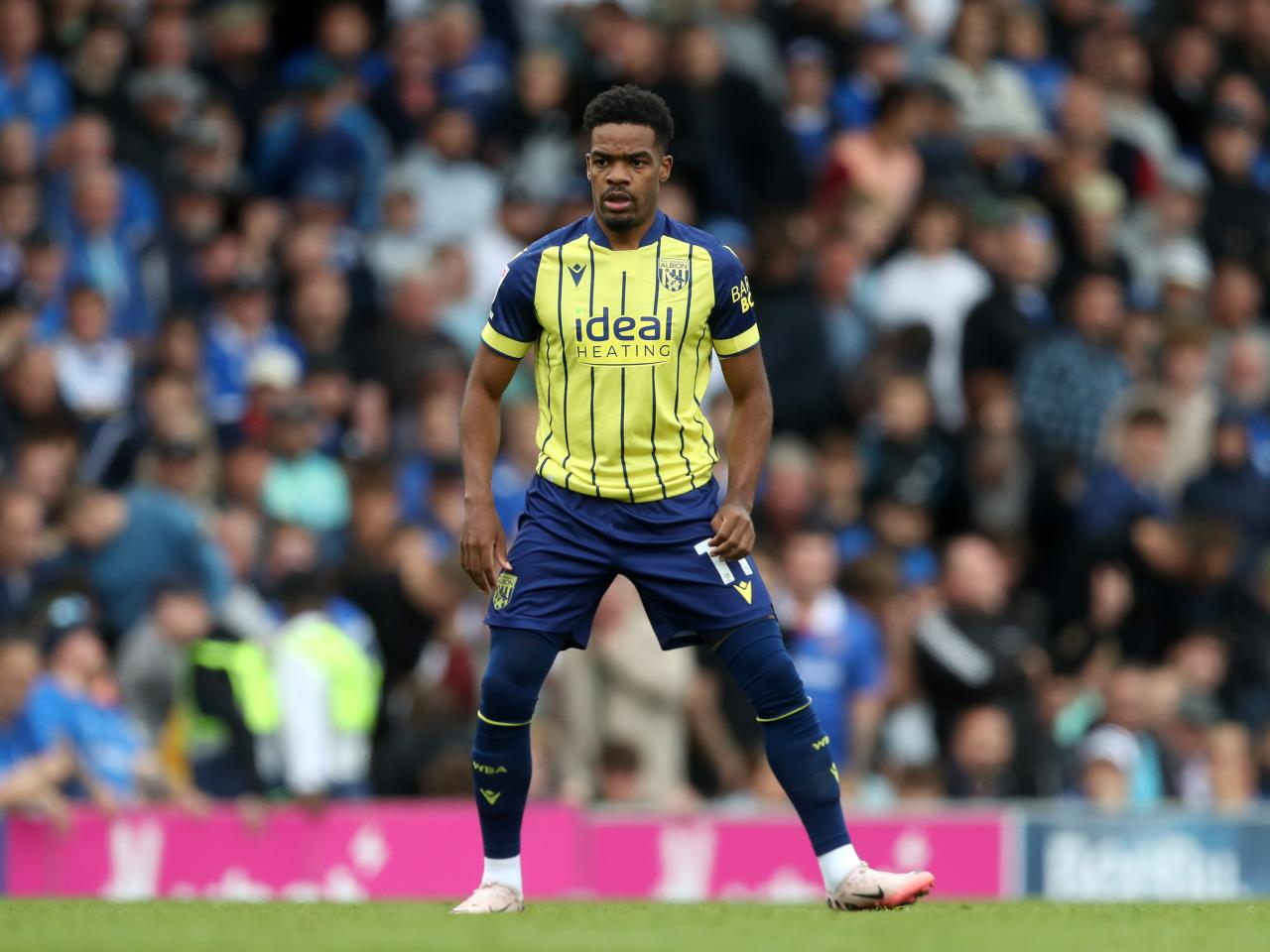 Albion in action against Portsmouth at Fratton Park, in yellow and blue away colours.