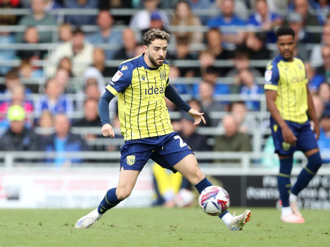 Albion in action against Portsmouth at Fratton Park, in yellow and blue away colours.