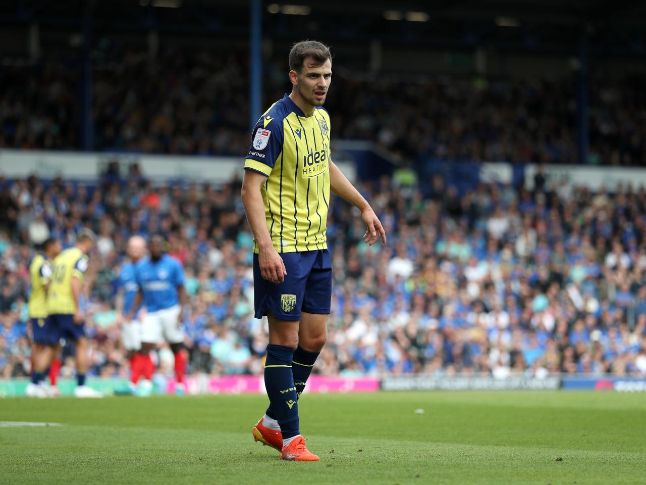 Albion in action against Portsmouth at Fratton Park, in yellow and blue away colours.