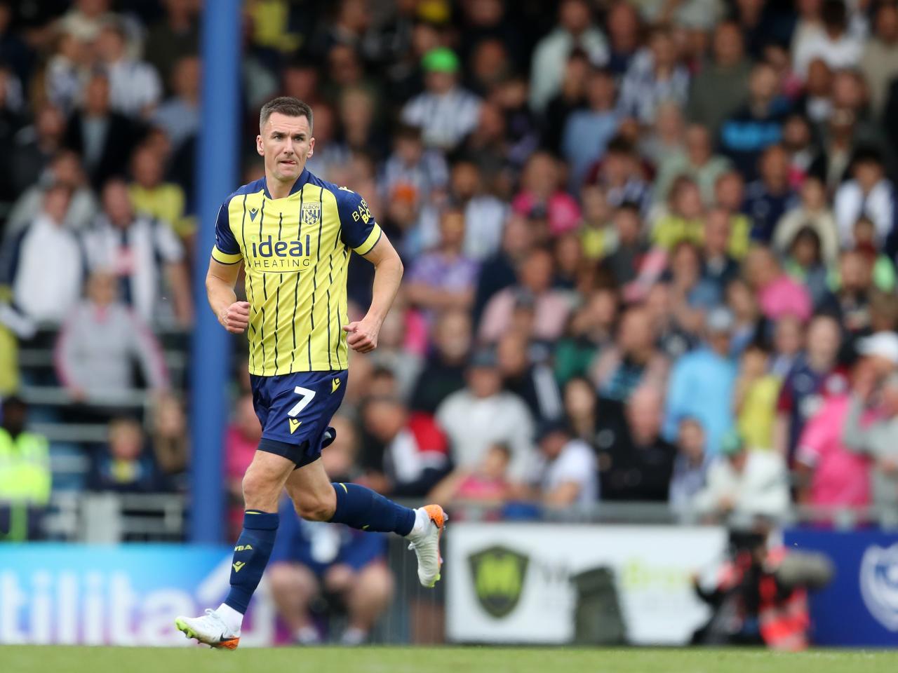 Albion in action against Portsmouth at Fratton Park, in yellow and blue away colours.