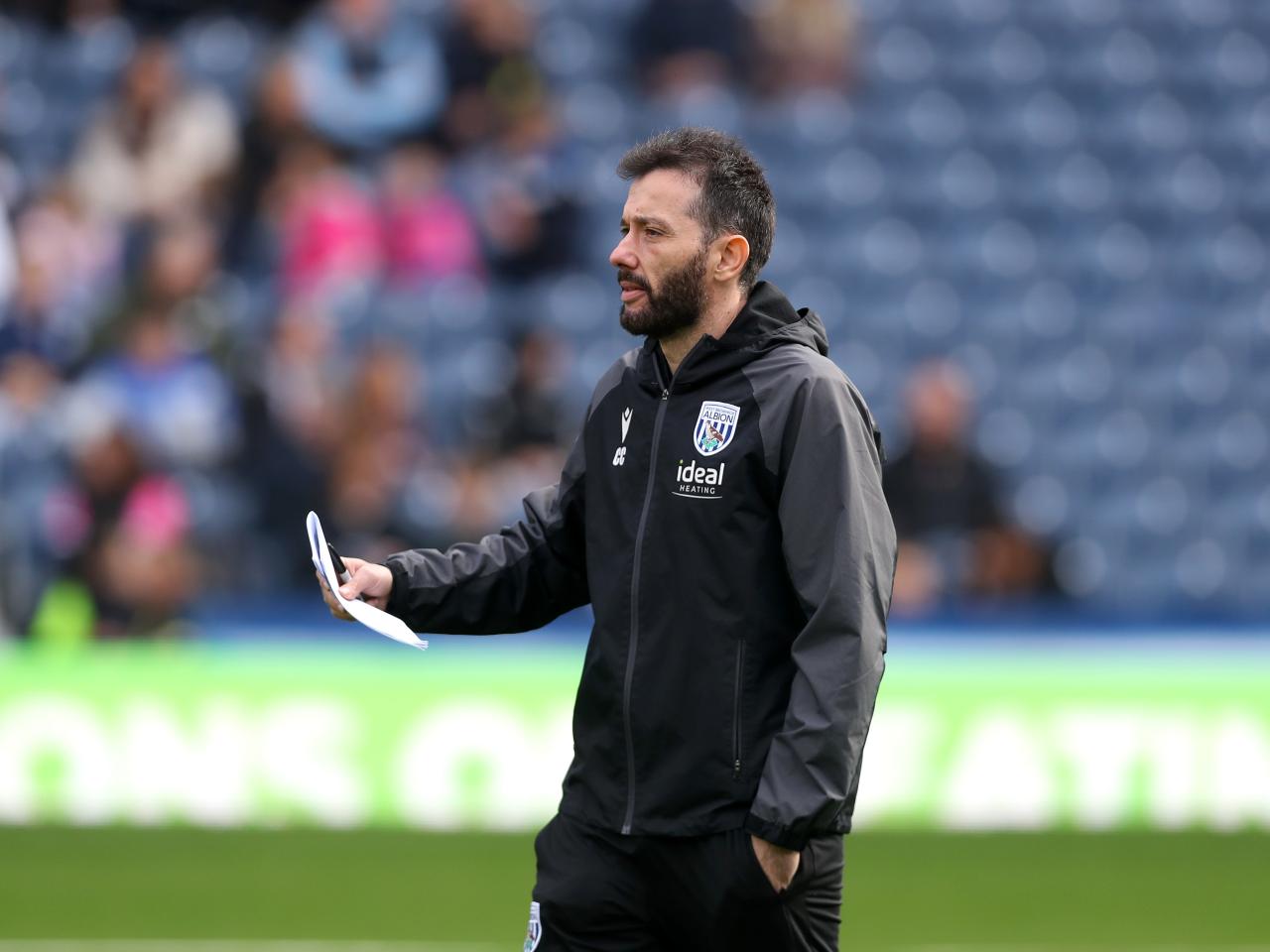 Carlos Corberán with a piece of paper in his hand during a training session at The Hawthorns 
