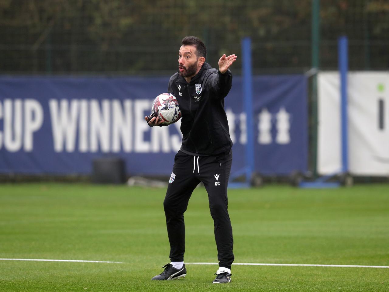 Carlos Corberán delivering instructions to his players during a training session 