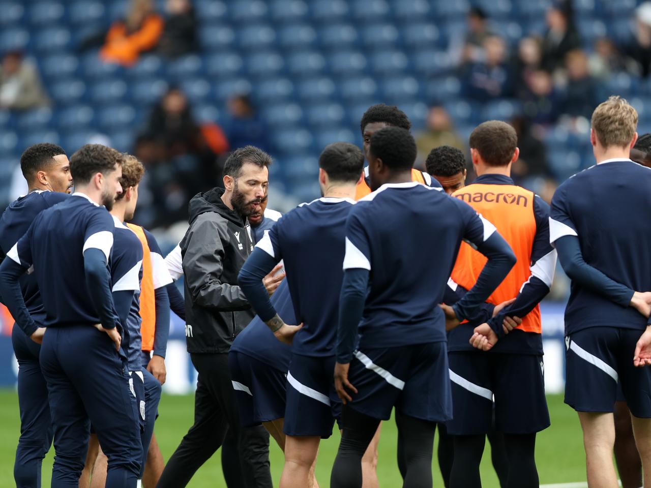 Carlos Corberán delivering instructions to his players on the pitch at The Hawthorns during a session 
