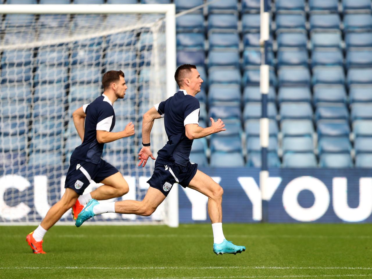 Several Albion players warming up before a training session at The Hawthorns
