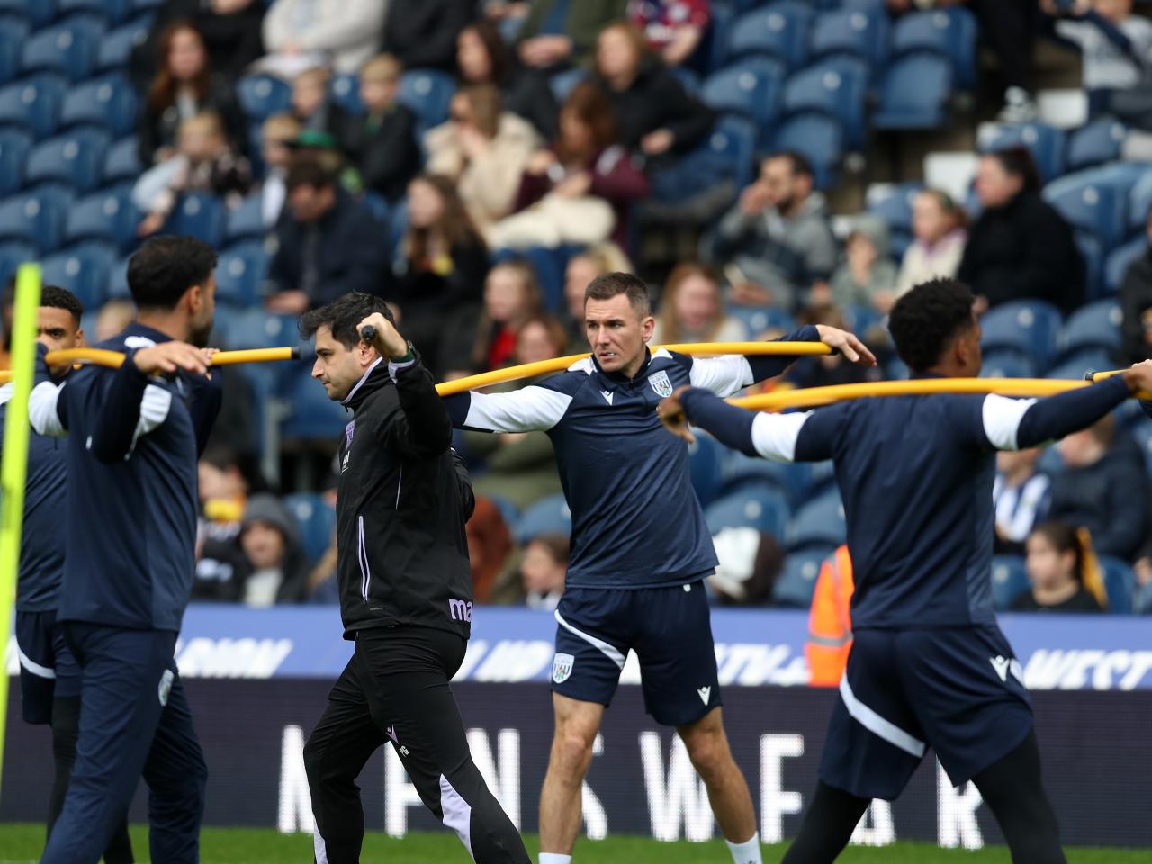 Several Albion players warming up before a training session at The Hawthorns