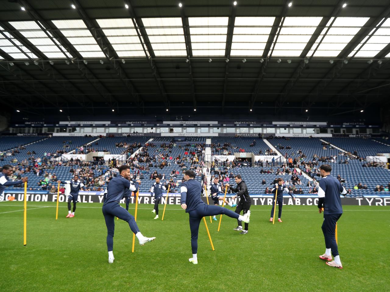 Several Albion players warming up before a training session at The Hawthorns
