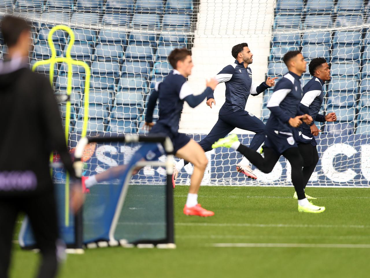 Several Albion players warming up before a training session at The Hawthorns