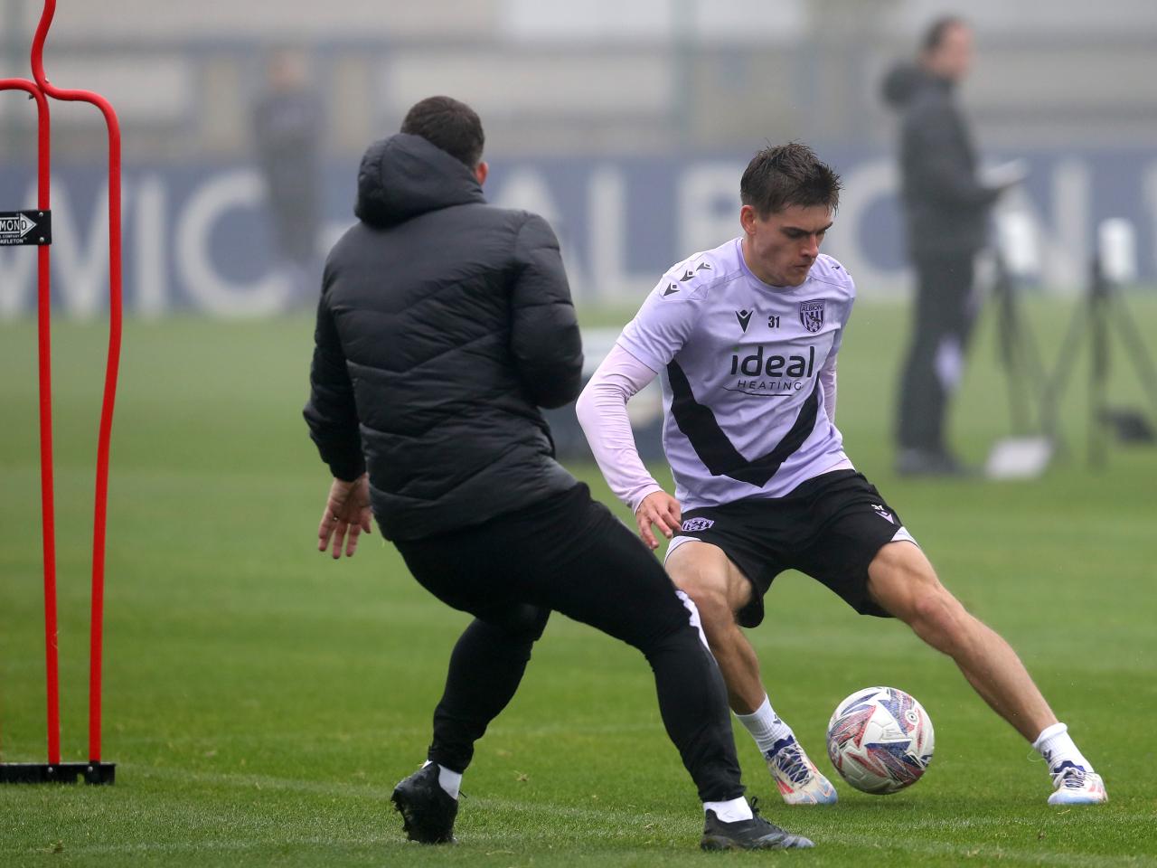 Tom Fellows dribbling with the ball during a training session 
