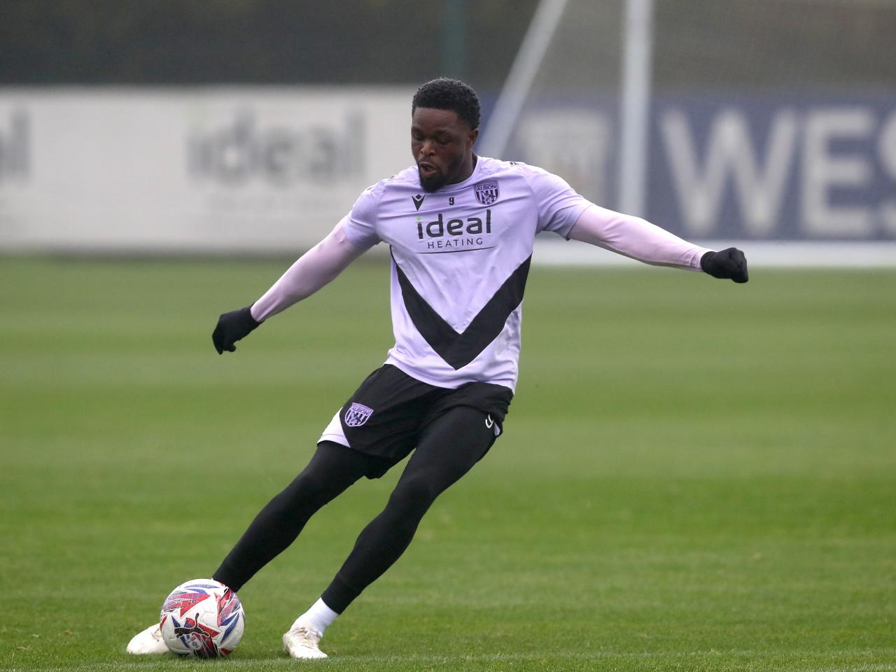 Josh Maja striking the ball during a training session 