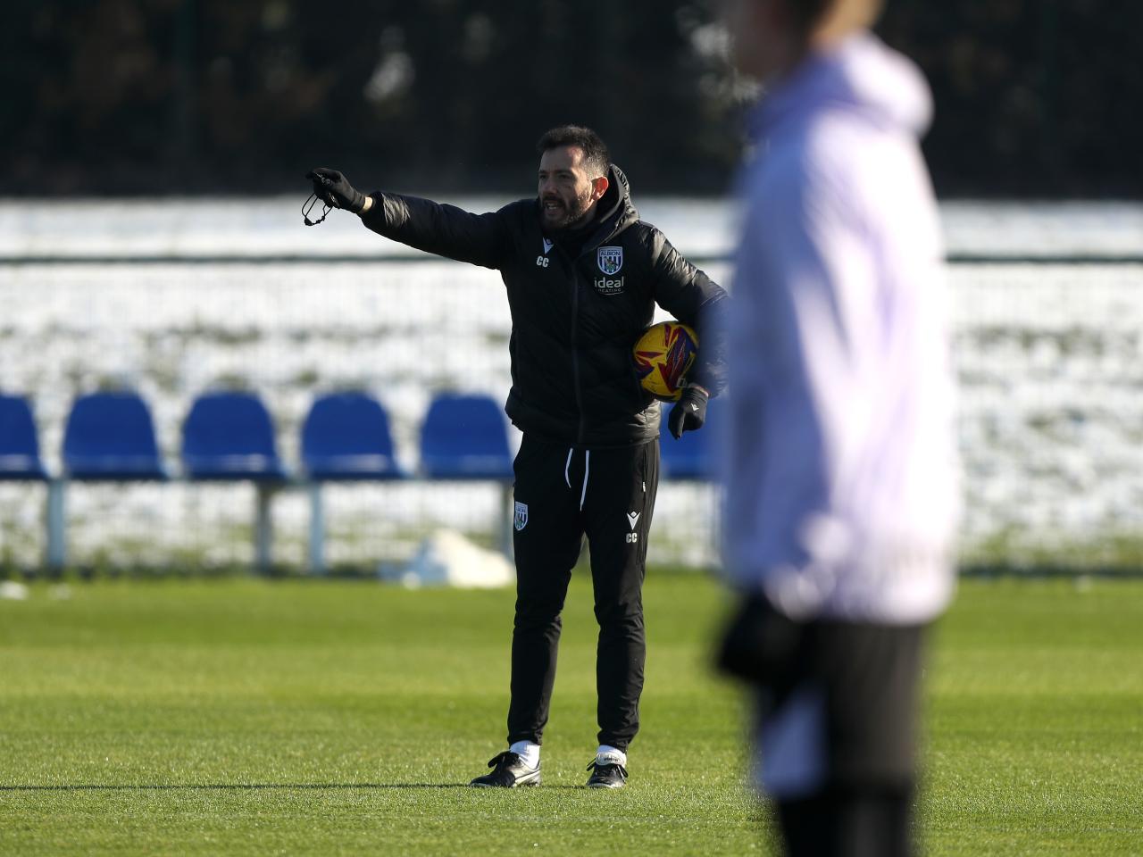 Carlos Corberán delivering instructions to his players on the training pitch 