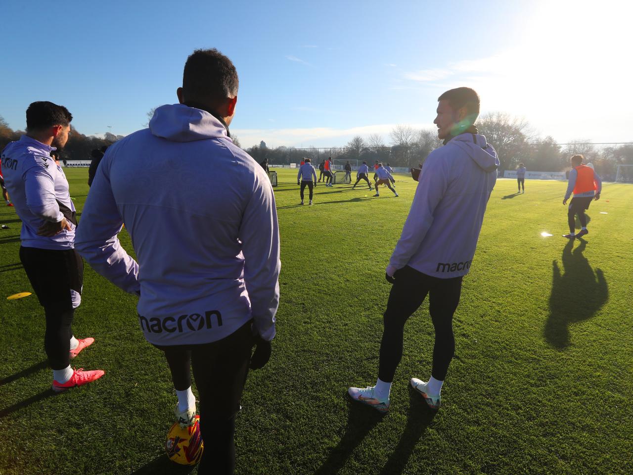 A group of players watching a training session 