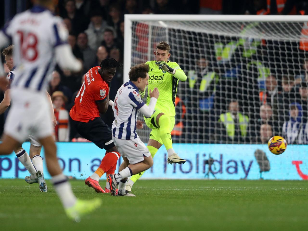 Alex Palmer clearing the ball under pressure at Luton 