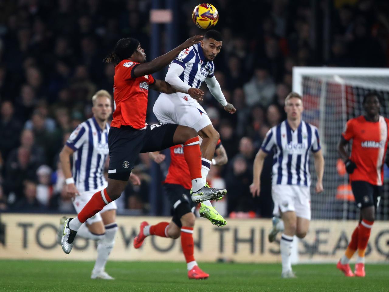 Several players jump to try and win a header at Luton 