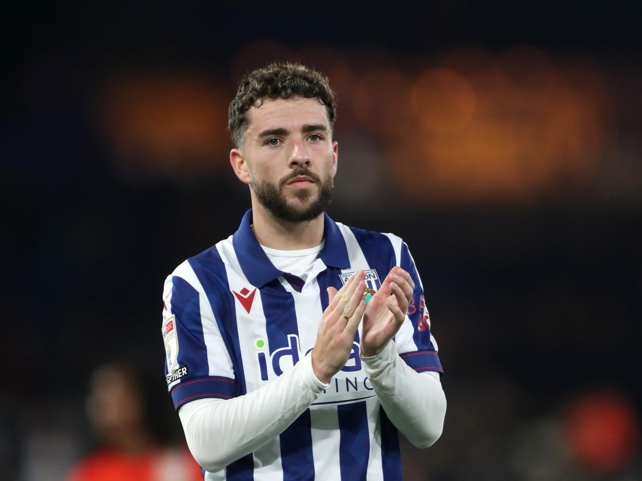 Mikey Johnston applauds Albion fans at full-time at Luton 