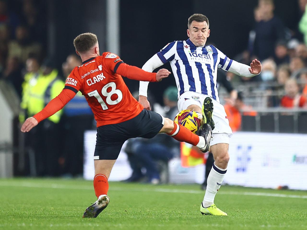 Jed Wallace battles for the ball with a Luton player 