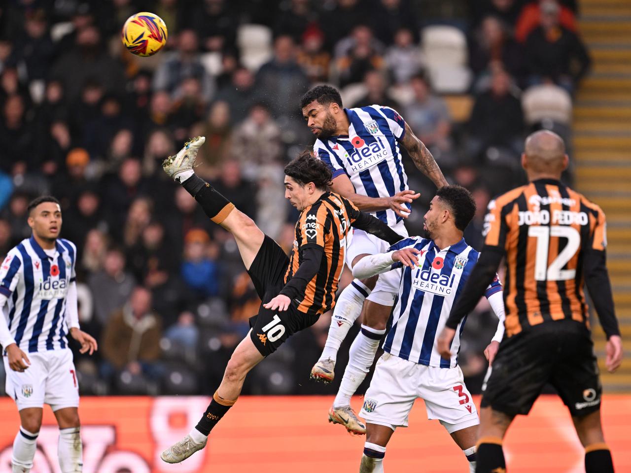 Several Hull and Albion players battle for the ball in the air