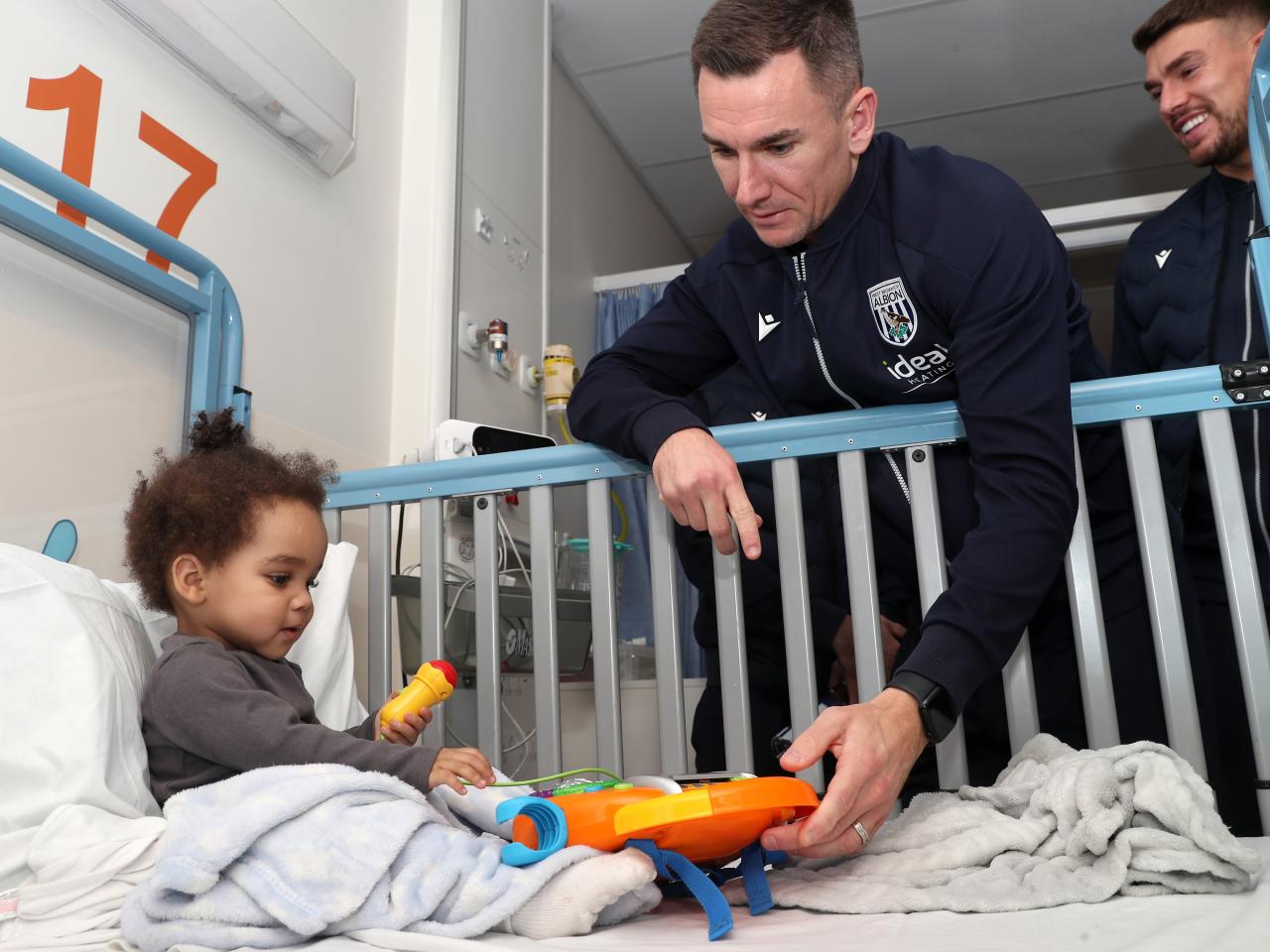 Jed Wallace interacts with a young patient at Midlands Metropolitan University Hospital 