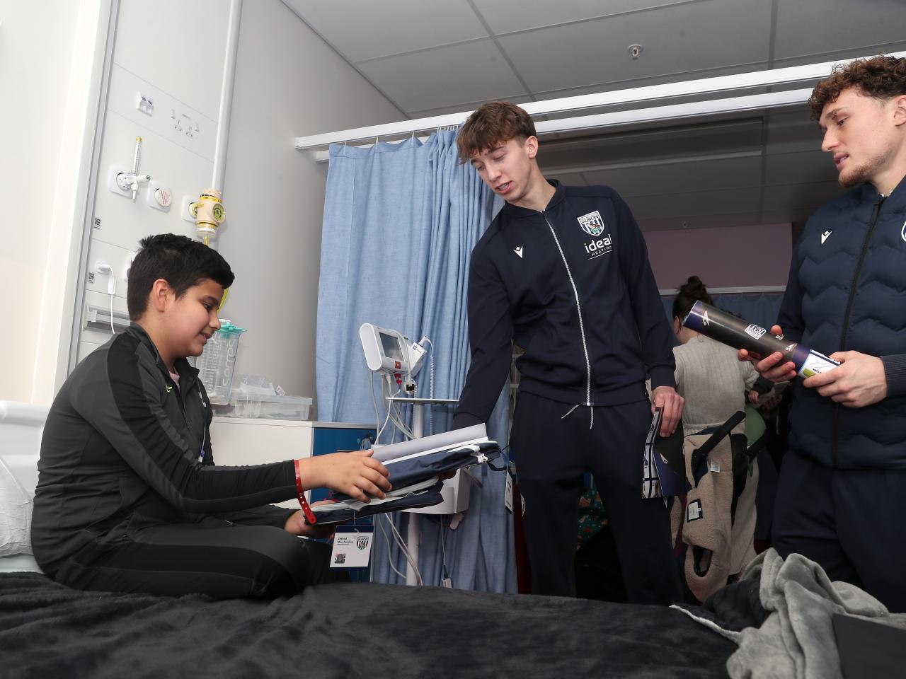 Albion players speak with a young patient at Midlands Metropolitan University Hospital 