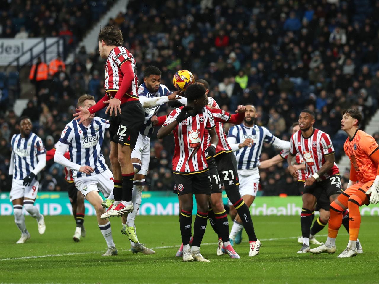 Several players try and win a header for Albion and Sheffield United 