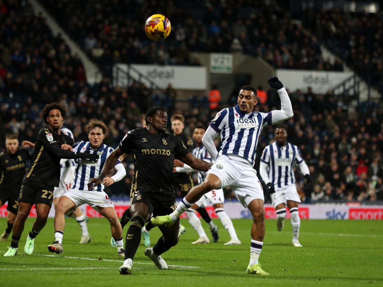 Several players try and make contact with the ball in the penalty area 
