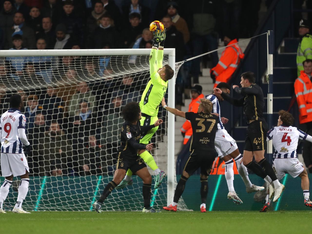 Alex Palmer catching a high ball with several players around him 