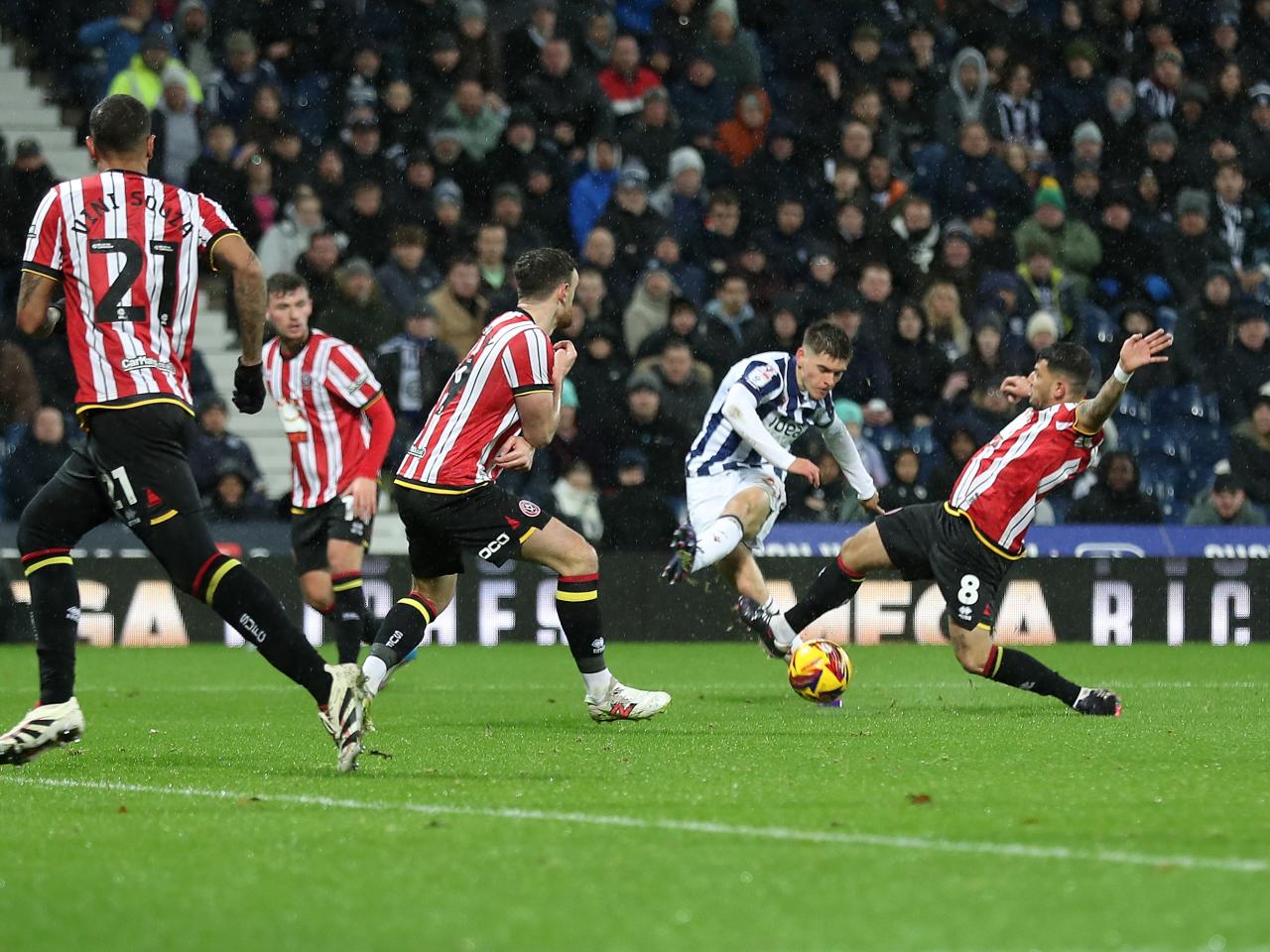 Tom Fellows shoots through a crowd against Sheffield United 