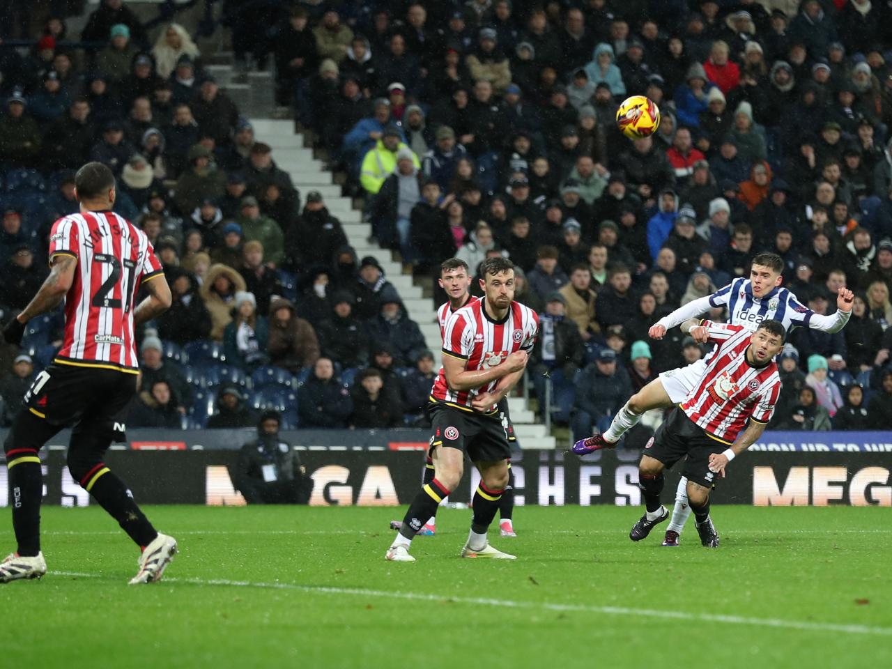 Tom Fellows shoots through a crowd against Sheffield United 