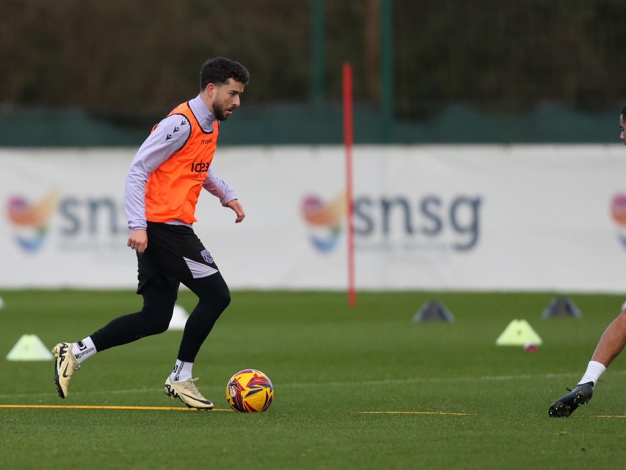Mikey Johnston running with the ball during training 