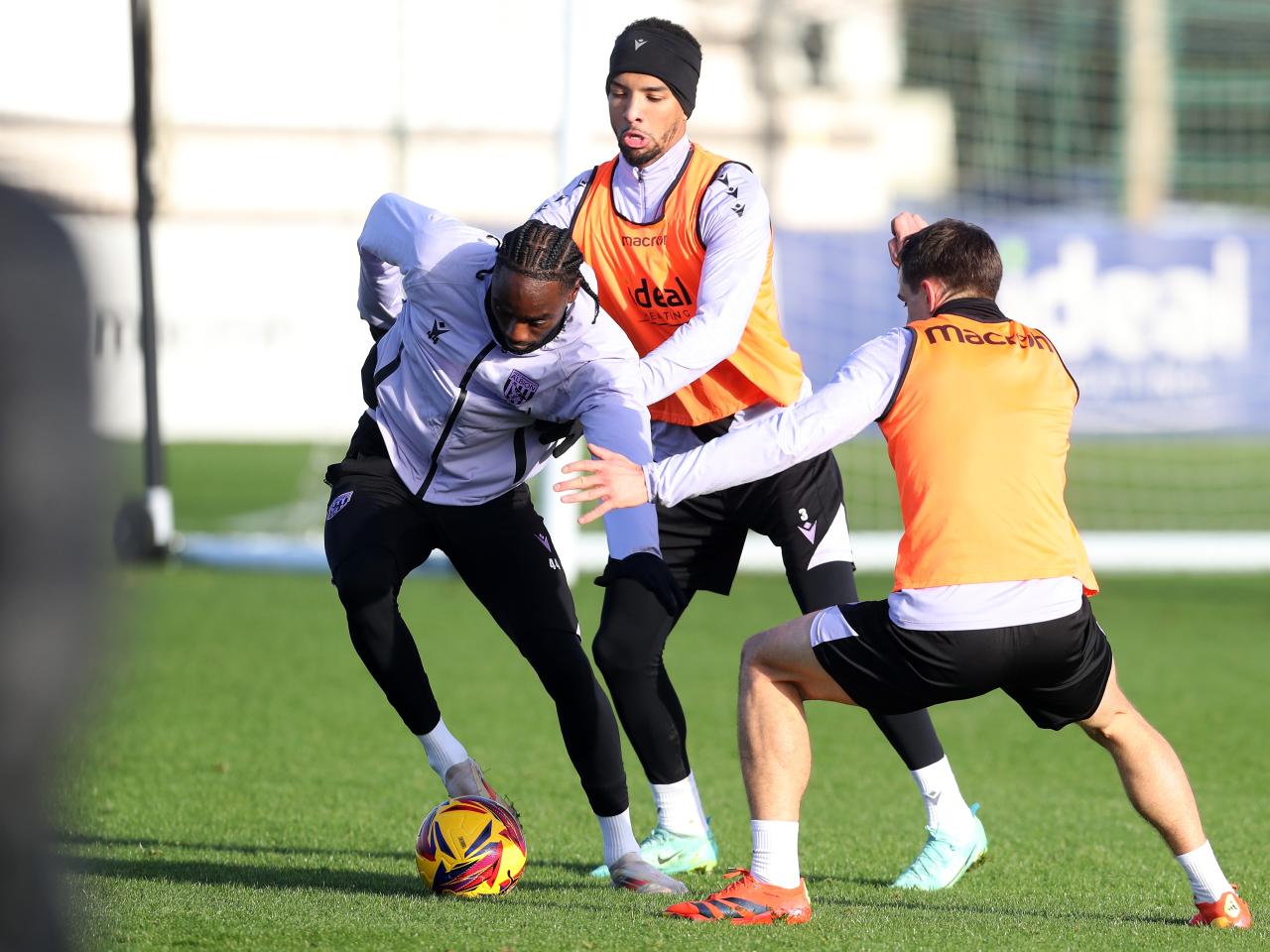 Devante Cole on the ball during training closely watched by Mason Holgate and Jayson Molumby 