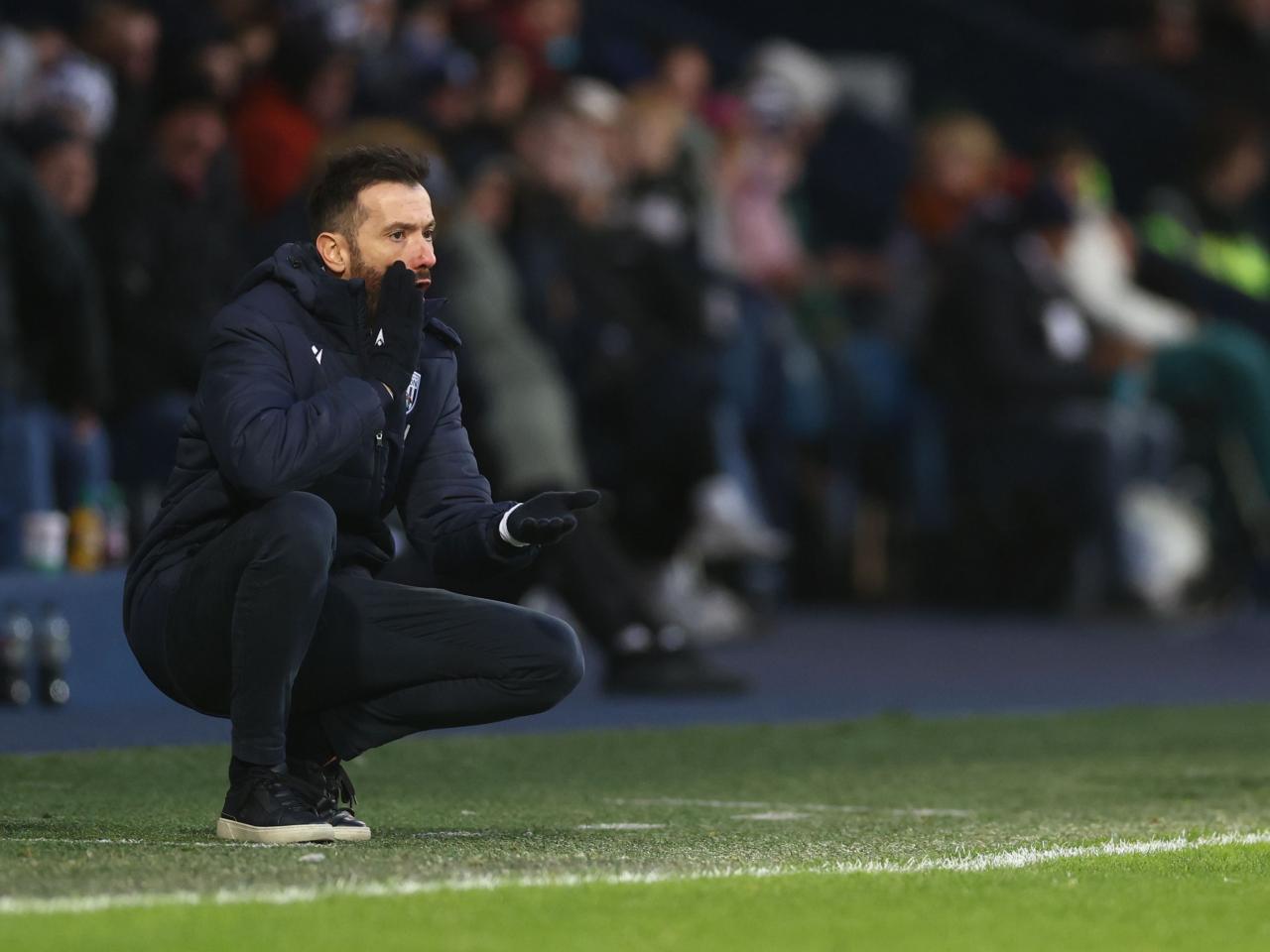 Carlos Corberán crouched down on the side watching the Bristol City game 