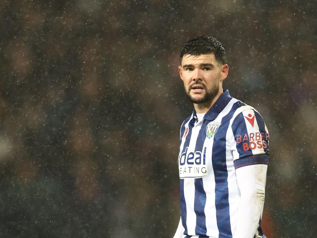 Alex Mowatt in action in the rain against Bristol City 