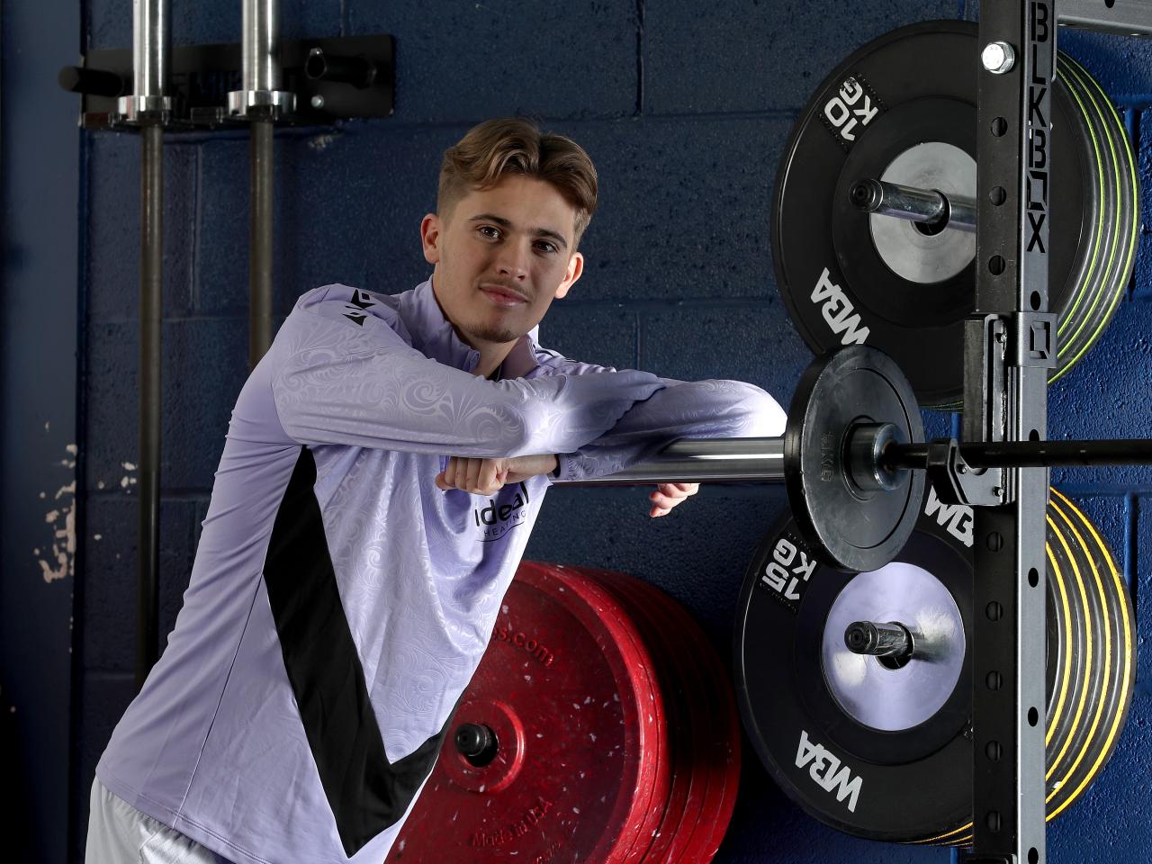 Isaac Price in Albion training gear leaning on equipment in the gym