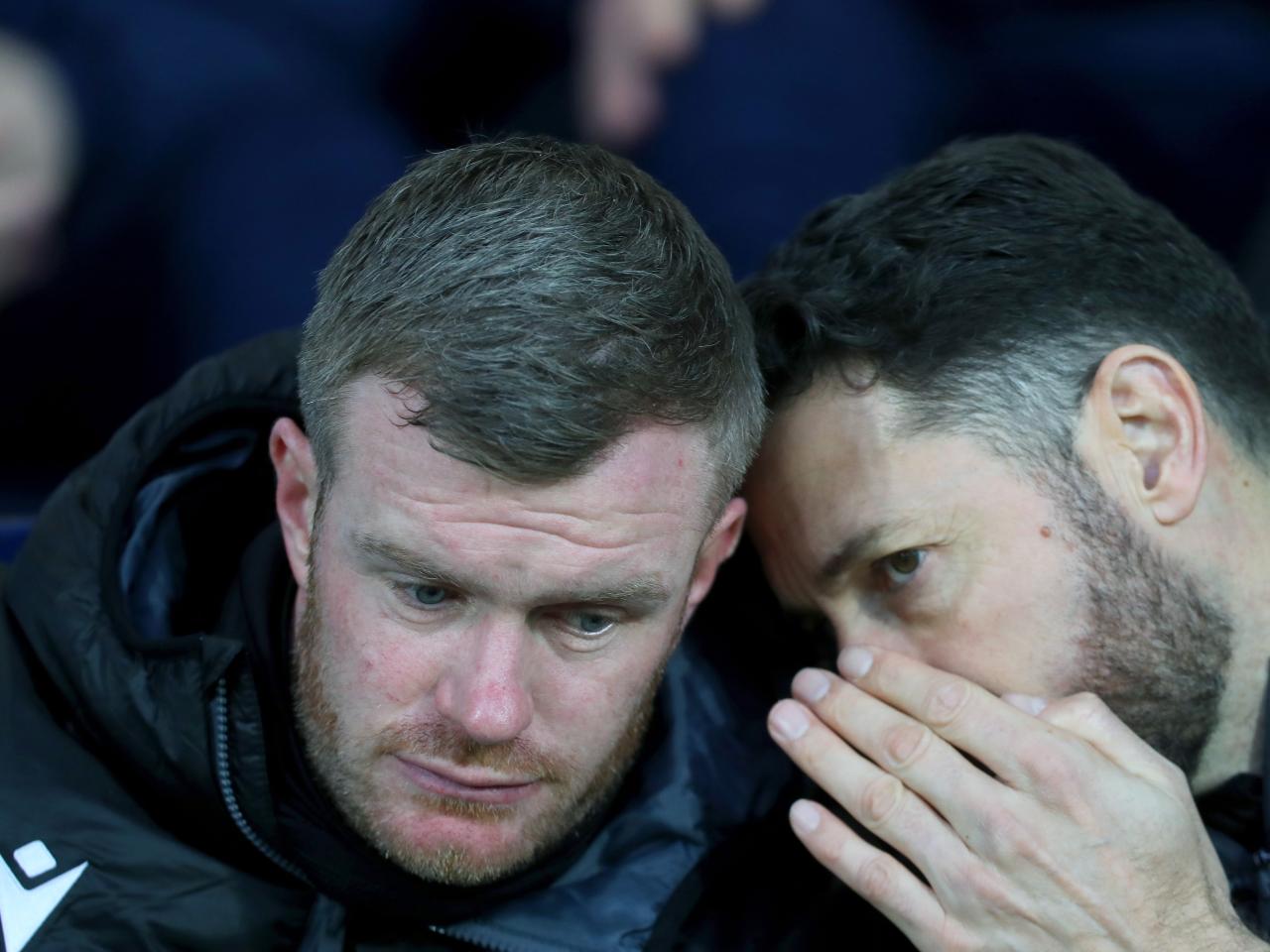 Damia Abella whispers to Chris Brunt 