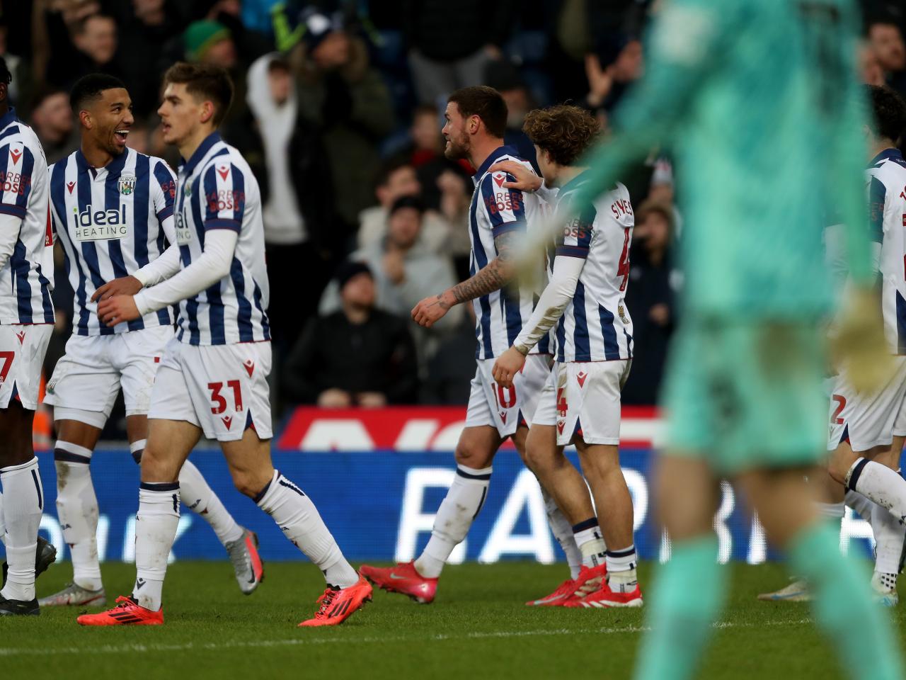 John Swift celebrates scoring against Portsmouth with team-mates