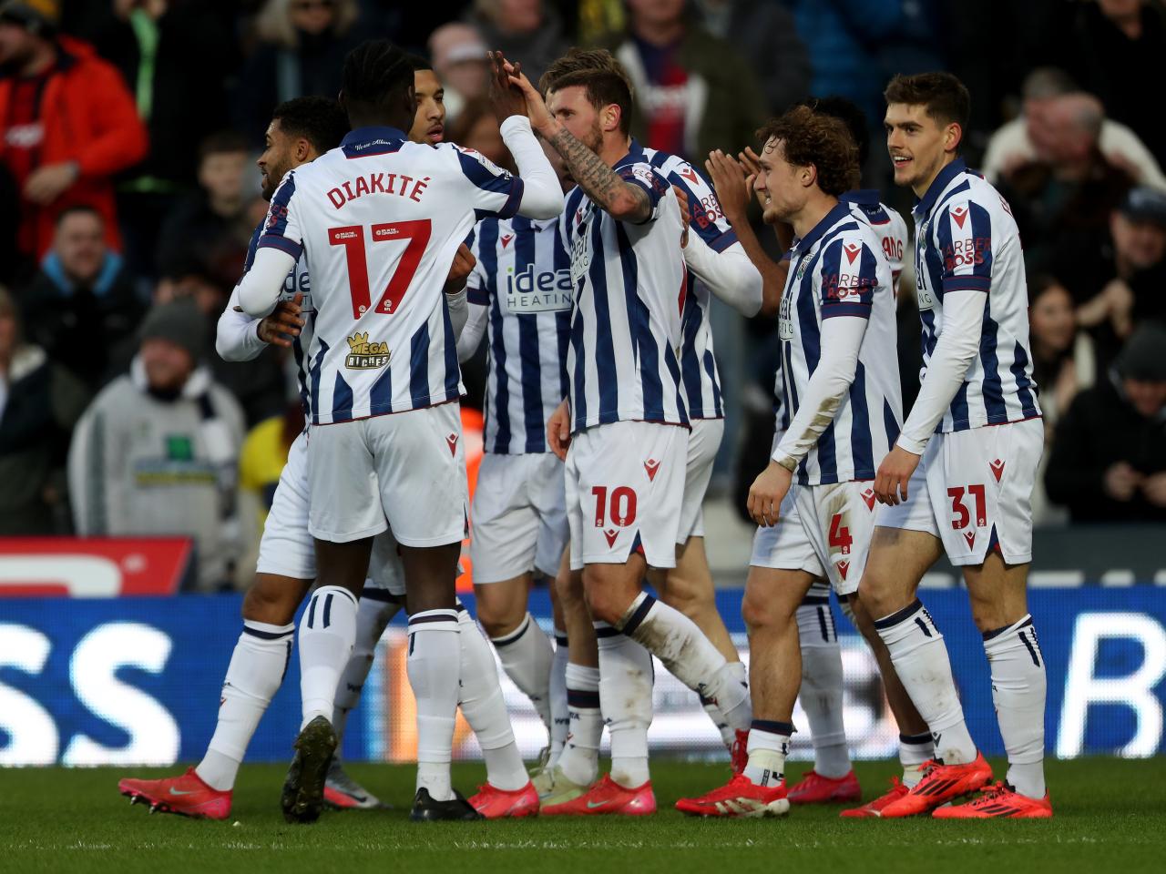 John Swift celebrates scoring against Portsmouth with team-mates
