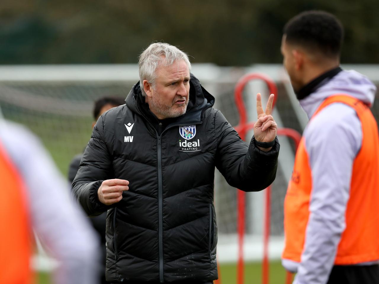 First team assistant head coach Mark Venus chatting to players on the training pitch