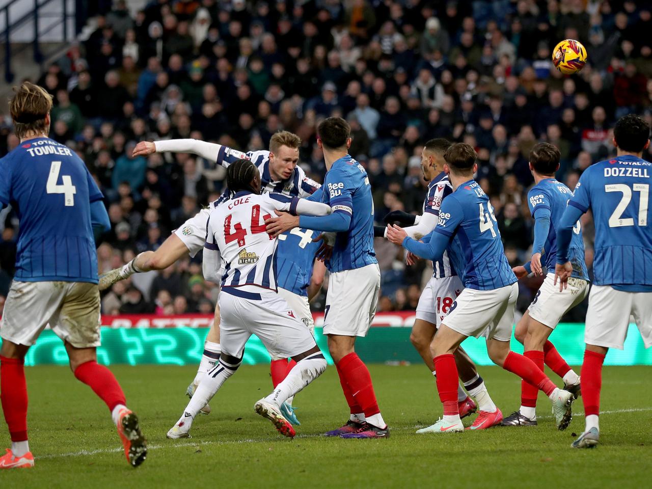 Plenty of Albion and Portsmouth players battling for the ball in the penalty area